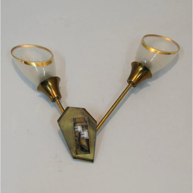 - Wall lamp from the 1960s made of glass decorated in white and gold - Brass and brass lacquered in black - 2 sockets for...