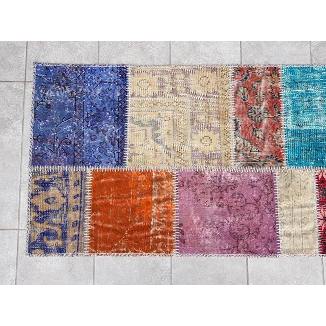 This is a vintage Turkish Oushak rug from the Mid 20th Century. The piece was hand-knotted.