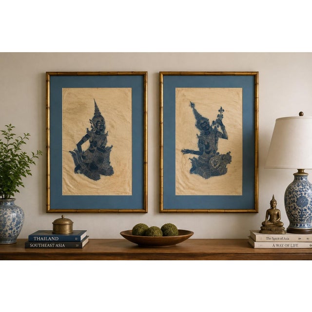 A striking pair of vintage Thai temple rubbings featuring intricately rendered traditional figures in rich blue on...