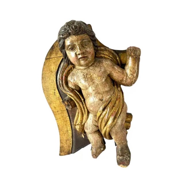 A Pair of Wooden Italian Baroque Putti Sculptures. Putti are hand-carved and retain traces of their original gilded and...
