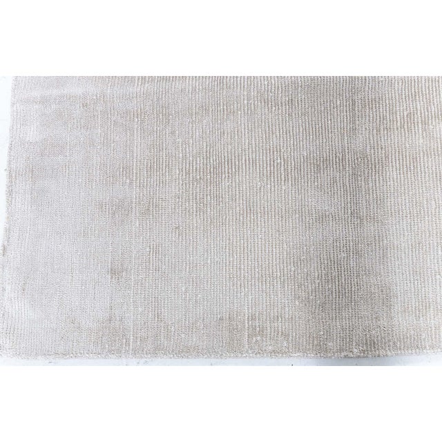 This modern solid beige rug exemplifies understated luxury through its refined texture and minimalist design. Crafted from...