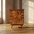 A matching pair of vintage bedside cabinets from Czechoslovakia, featuring richly figured burl veneer, warm-toned wood,...