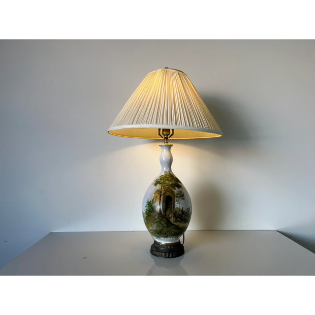 Gorgeous Vintage French hand- painted porcelain table lamp with European country landscape scene motif. Measures: From the...