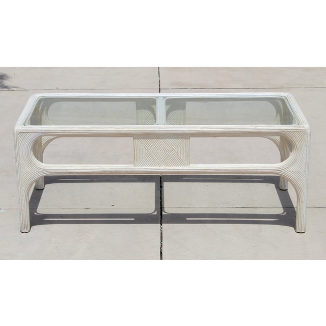 Bring effortless coastal style to your home with this beautiful vintage 1980s pencil reed rattan coffee table. Featuring a...