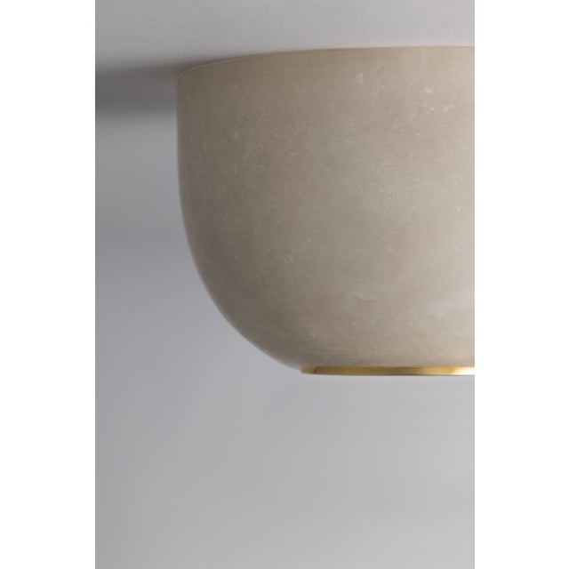 The Bains Corner flush mount uses specialty stone to create the perfect petite overhead light. The natural veining of the...