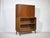 Mid-century teak secretary/bar with display cabinet, 1960s. Two-part design with a closed writing surface at the top and a...