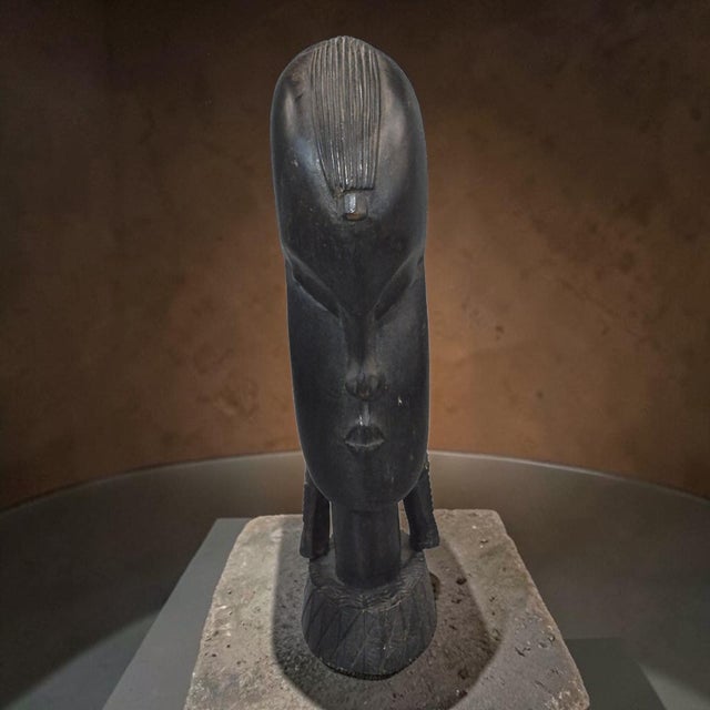 This vintage hand-carved iron wood tribal African bust sculpture is a unique and handmade piece that captures the essence...