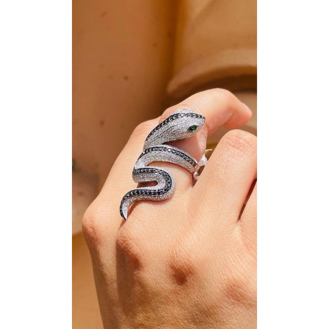 Tsavorite Eye and Diamond Snake Coil Ring in 18K Gold featuring natural diamonds of 3.5 carats and tsavorite of 0.1 carat....