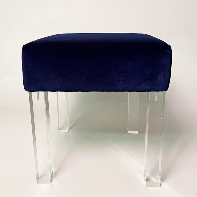 A pair of stunning square low stools with cushions upholstered in fine navy velvet and installed with solid lucite legs....