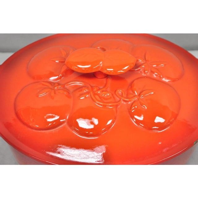 Technique 4 Quart Red Cast Iron Dutch Oven Covered Pot with Tomato Design on Lid. Circa Late 20th Century. Measurements:...