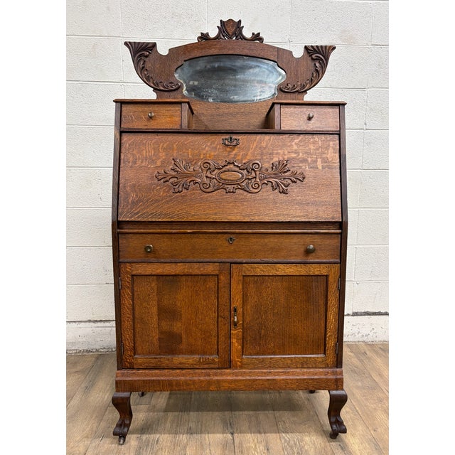This is a gorgeous antique Victorian oak secretary desk, likely dating from the late 19th or early 20th century. It is...