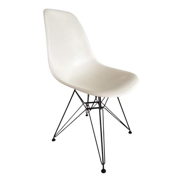 Vitra Eames DSR chair in white with black Eiffel bases, designed by Charles & Ray Eames and labelled by Vitra. This piece...