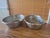 Pair of vintage woven metal baskets featuring a tight crisscross lattice pattern and a bright silver‑tone finish. Their...