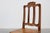A finely carved oak side chair from 18th‑century France, executed in the Régence style. The chair features a scrolled...