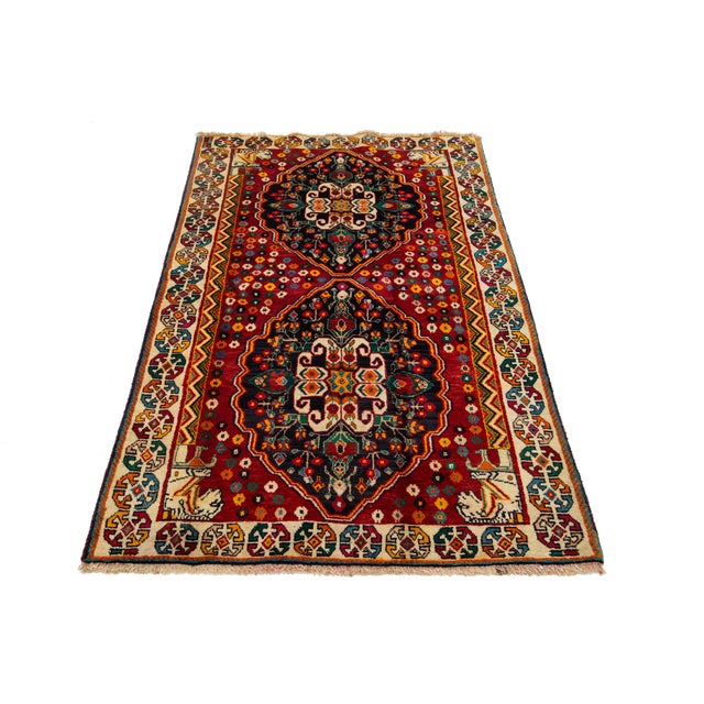 This beautiful Persian Hand-knotted wool rug has a red field with multicolor accents allover the design. This rug measures...