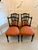 A decorative set of four Victorian ebonised and gilt dining chairs dating to circa 1880, with elegant spindle backs,...