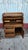 Sturdy oak rolltop desk has a dark brown finish and is manufactured by Oak Crest. This piece features a curved rolltop...