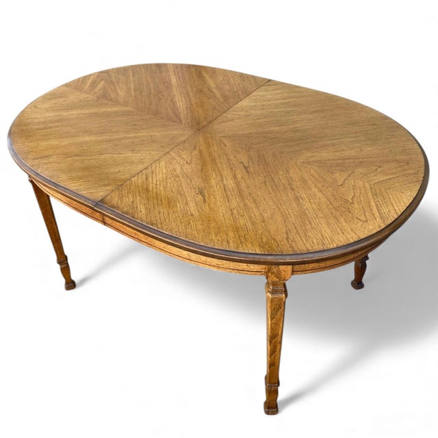 Vintage Bookmatched Veneer Oval Extension Dining Table. An elegant vintage dining table with an oval bookmatched-veneer...