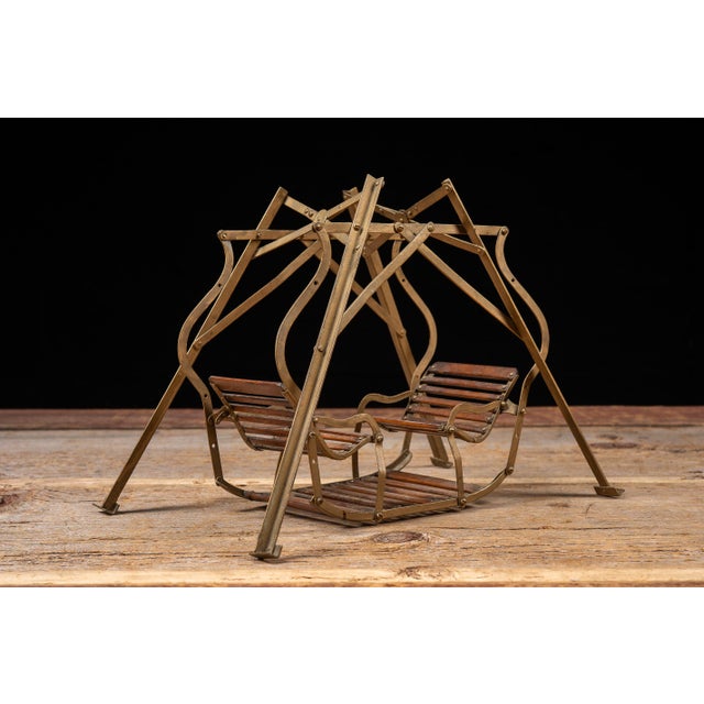 Miniature salesman sample of a folding lawn swing featuring a painted cast metal frame with wooden slat seats and foot...