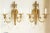 Pair of French Louis XVI style (20th Century) solid and gilded brass wall sconces with fluted design, two scroll arms, an...