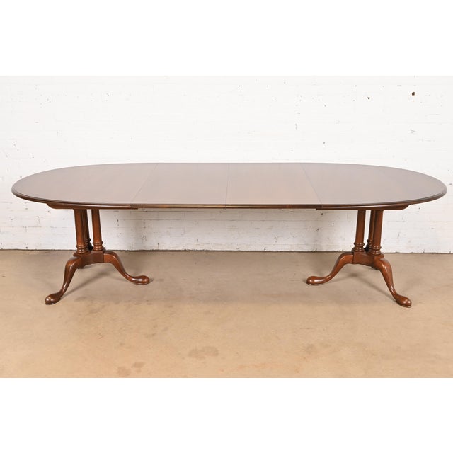 An exceptional Georgian, Regency, or Queen Anne style double pedestal extension dining table By Baker Furniture USA, Circa...