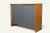 A stylish side table from the 1960s, with a clean, graphic design. It combines a honey-toned wooden frame with two bluish-...