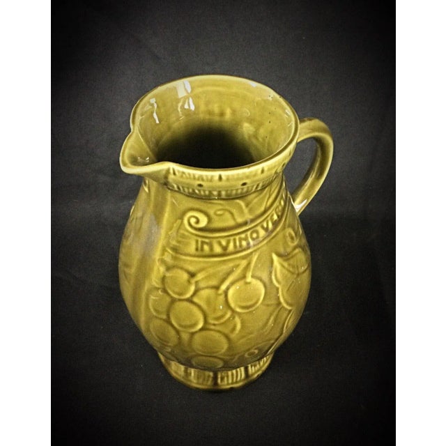 This elegant pitcher or jug from Sarreguemines features a detailed grape and vine flower motif, showcasing the...