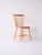 Vintage 1960s wooden chair, with birch structure and teak seat, characterized by a backrest made of wooden trunks. This...