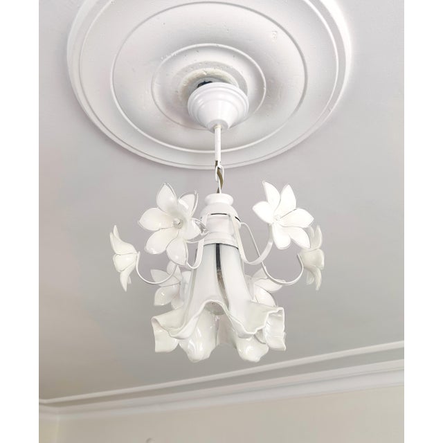 Beautiful 1980s vintage Murano glass chandelier featuring white floral design with white metal frame. This rare Italian...