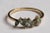 A lovely cluster of six marquise, faceted green tourmaline gemstones with two round, brilliant cut diamonds interspersed....