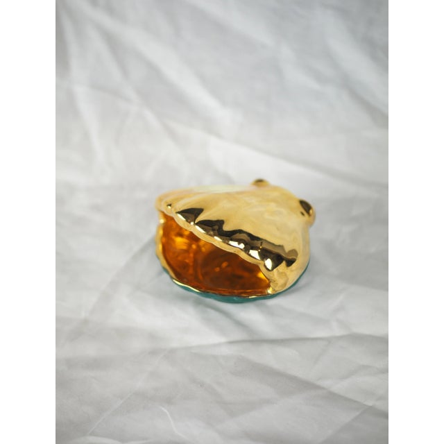 Limoges porcelain tray in the shape of a gilted scallop shell with a duck green background. This very curious storage...