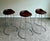 A sophisticated set of three swivel bar stools by McGuire, showcasing the brand’s signature balance of refined organic...