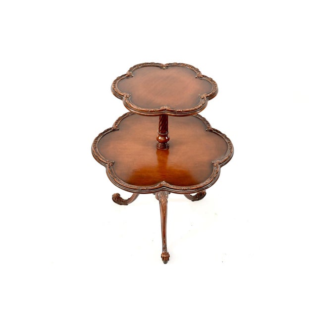 Beautiful vintage two-tier occasional table with scalloped “clover” shaped/ “pie crust” shelves and a fluted pedestal...