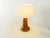 Wonderful table lamp from the 1960s. High quality solid wood foot made of teak with a lampshade in cream. Quality...