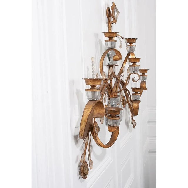 An enormous Maison Baguès-style sconce from circa 1960 France, featuring gilded iron scrolled arms rising from an urn...