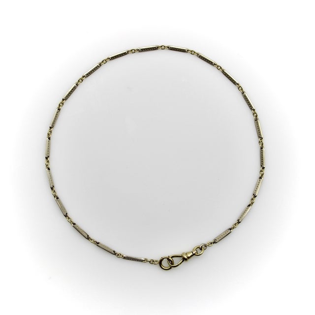This is a versatile Art Deco watch chain, made up of a series of white gold fill bar links with embossed decoration on...