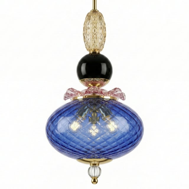 Its vertical structure combines Murano glass spheres and discs in cobalt blue, pink, and amber tones, creating a vibrant...