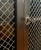 Wood Mid-Century Regency / Directoire Style Black & Gilt Painted Cabinet / Bookcase / Bar With Inset Wire Screen & Key, Attrib. To Baker Furniture For Sale - Image 7 of 12