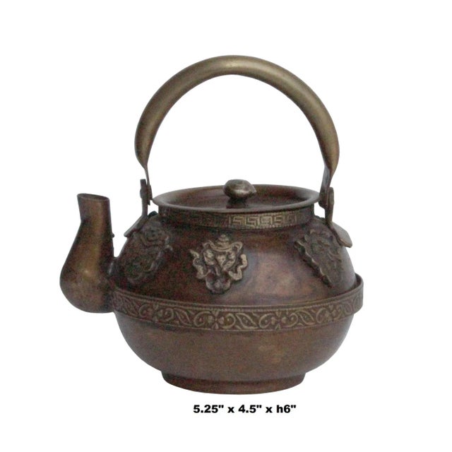 This is a handmade metal bronze color finish teapot shape display with relief motif accent design. For display purpose,...