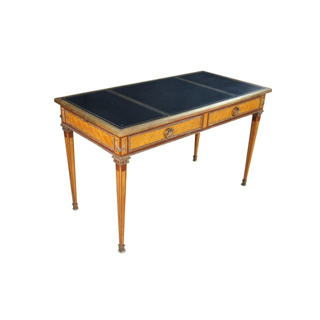 An exquisite French Directoire Bureau Plat or Library Table, Circa 1920. Features a rectangular form made from kingwood...