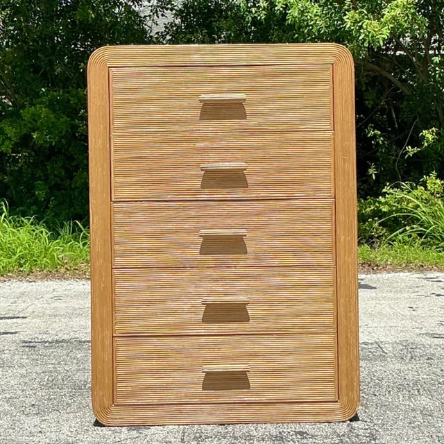 Elevate your décor with the American-style Vintage Coastal Waterfall Pencil Reed Chest of Drawers. Featuring the timeless...