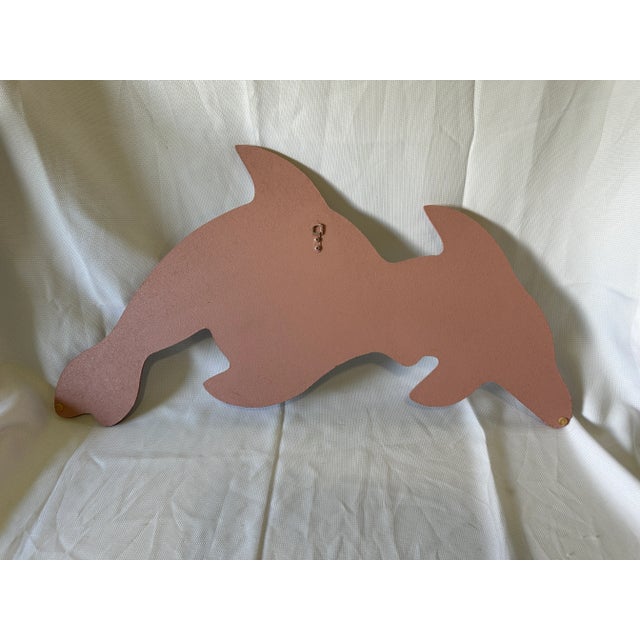 Add a colorful touch of coastal Florida to your beach motif with this delicious twin dolphin wall mirror. The large...