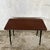 A stylish mid-century modern teak side table featuring a beautifully understated design, warm wood tones and distinctive...