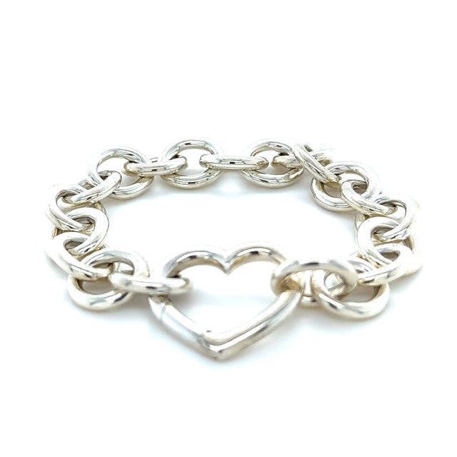 A rare Tiffany & Co. bracelet crafted in sterling silver, featuring a classic round link chain with the distinctive heart-...