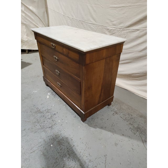 A beautiful 19th-century French Louis Philippe commode crafted in richly figured walnut and topped with a substantial...