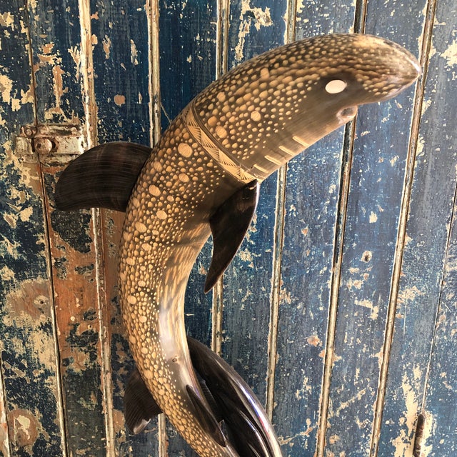 A masterful carving of a shark in a leaping position and mounted on a marble base. Beautiful details and colors. A unique...