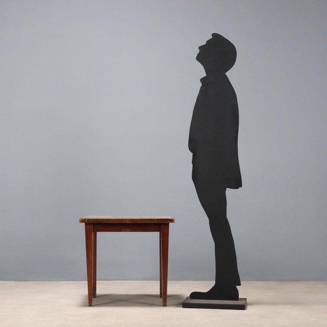 Coffee table with stained beech frame, mahogany veneer top, and clear glass top. Fair condition. This piece is attributed...