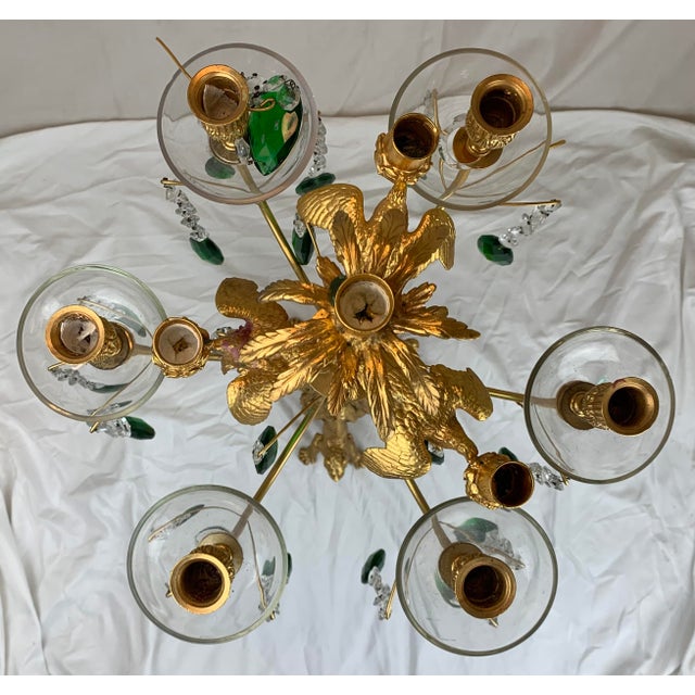 Vintage Gilded Bronze 10 candle candelabra with clear and green crystals and round glass bobeches. Supported by an...