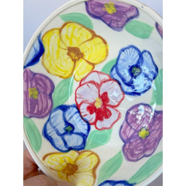 The most charming hand painted artisan studio pottery bowl with colorful array of flowers on a white clay body. Cheerful...