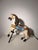 Decorative vintage carousel horse sculpture crafted in carved and painted wood, presented on a simple dark metal support....